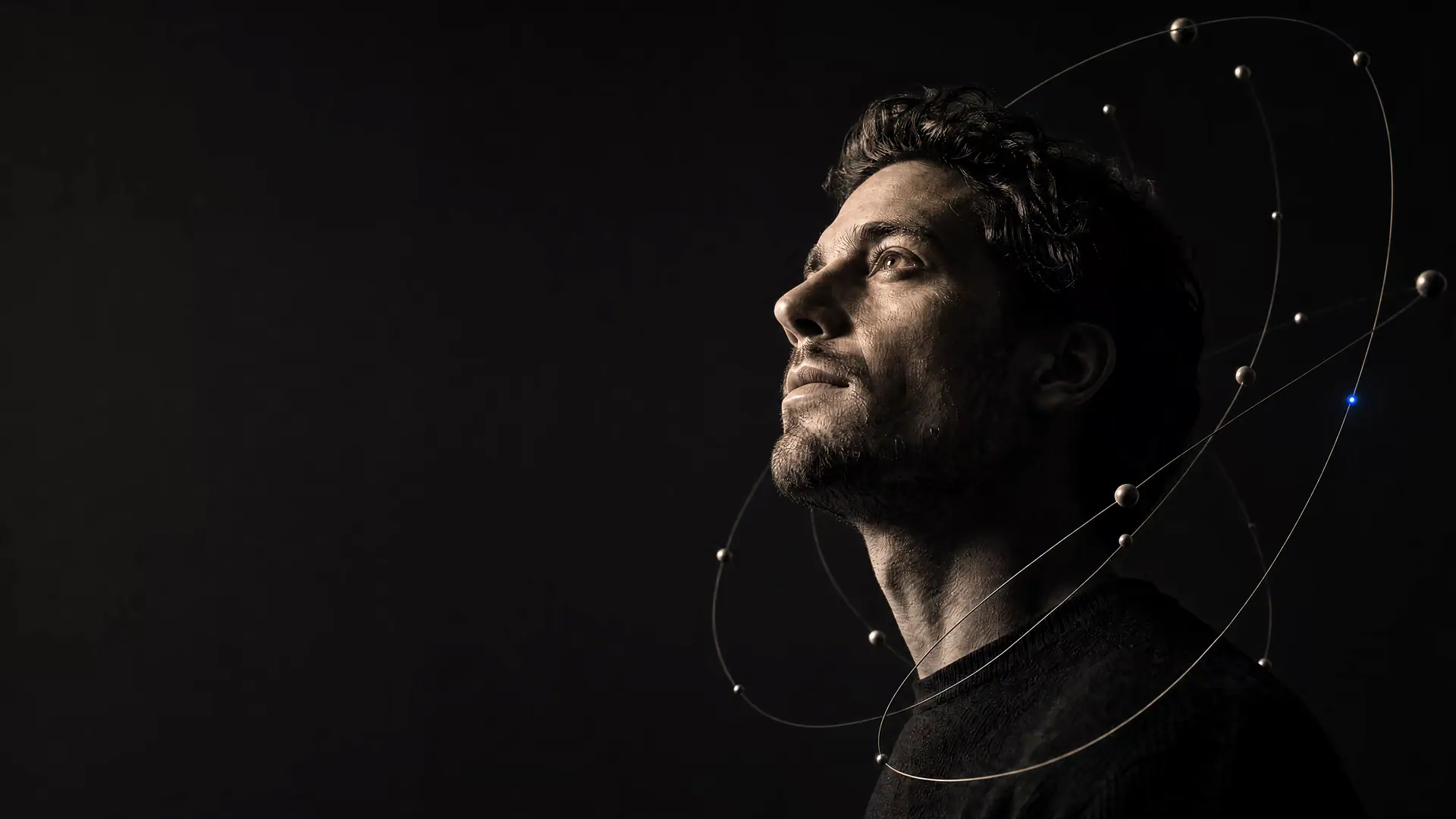 A contemplative man in profile surrounded by delicate orbital curves with one cobalt point.
